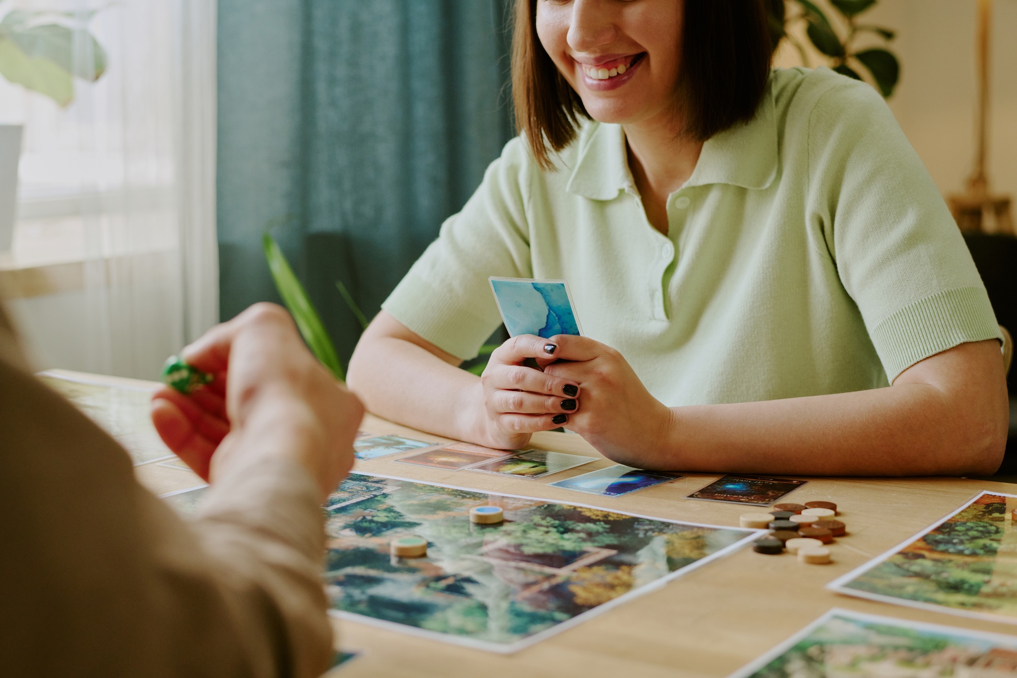 Smiling Woman Playing Board Game With Her Boyfriend